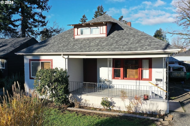 rear view of property featuring a porch