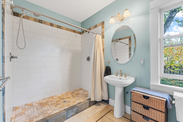 bathroom featuring tile patterned flooring, sink, and walk in shower