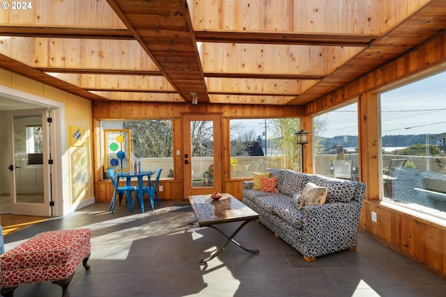 sunroom with wood ceiling, plenty of natural light, and beam ceiling