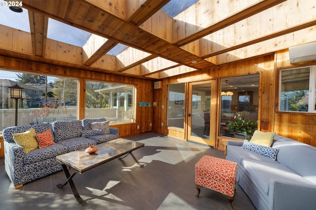 sunroom with vaulted ceiling with skylight and an AC wall unit