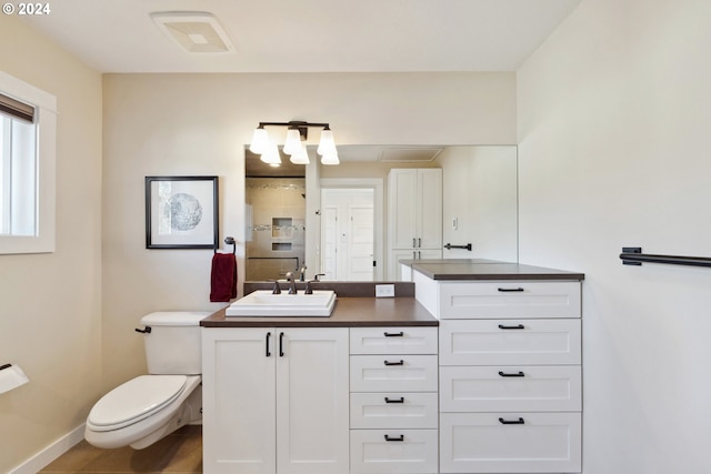 bathroom with vanity, tile patterned flooring, and toilet