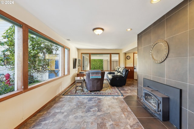 living room with tile walls and a wood stove