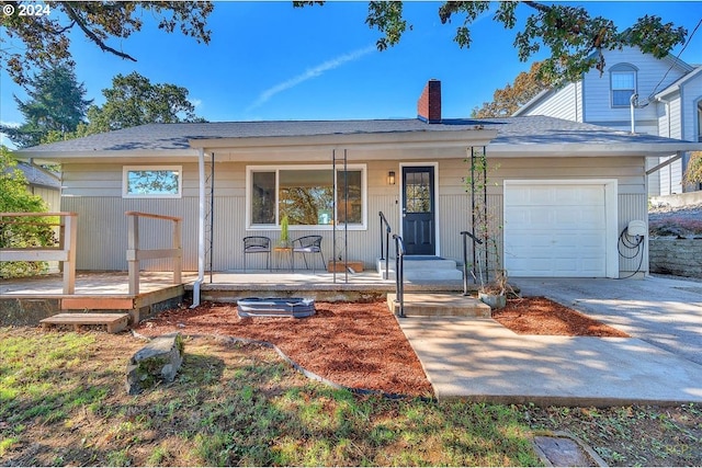 view of front of home with covered porch and a garage