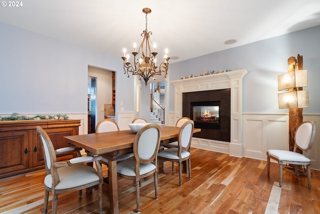 dining room with light hardwood / wood-style flooring and a multi sided fireplace