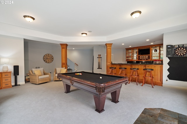 rec room featuring light colored carpet, indoor bar, and ornate columns