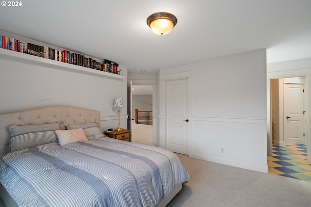 bedroom featuring light colored carpet and a closet