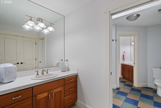 bathroom featuring vanity and toilet