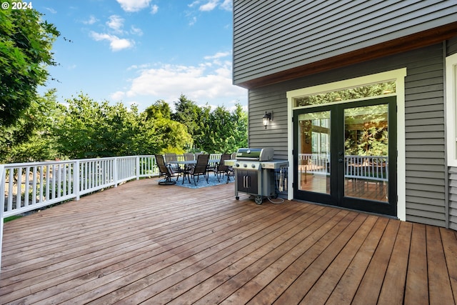 wooden terrace with grilling area and french doors