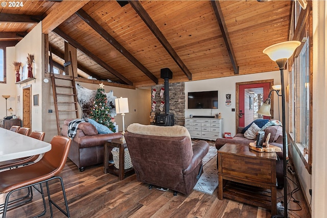 living room featuring a wood stove, dark hardwood / wood-style flooring, beamed ceiling, and high vaulted ceiling