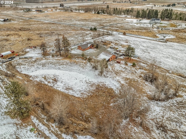 snowy aerial view featuring a rural view