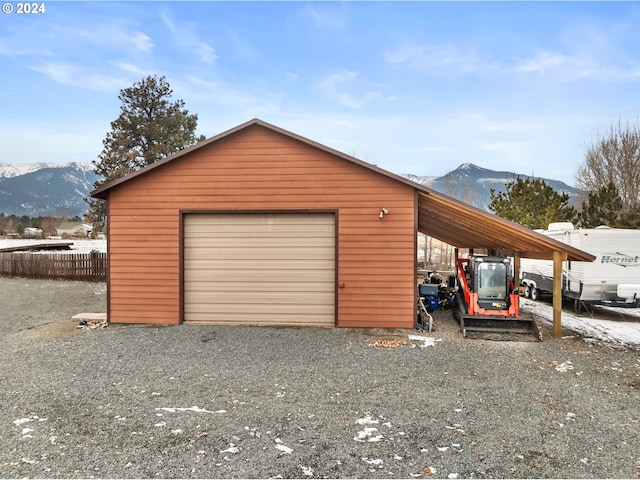 garage featuring a mountain view and a carport