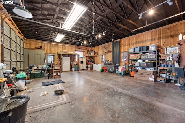 garage with wood walls and white refrigerator