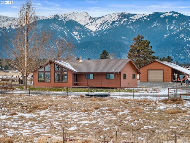 view of front of property with a mountain view and an outdoor structure