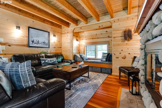 living room featuring beamed ceiling, hardwood / wood-style floors, wooden ceiling, and wooden walls