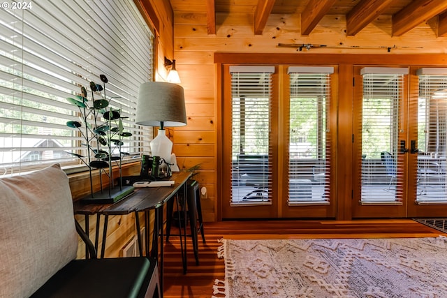 doorway to outside with french doors, wooden walls, and a healthy amount of sunlight