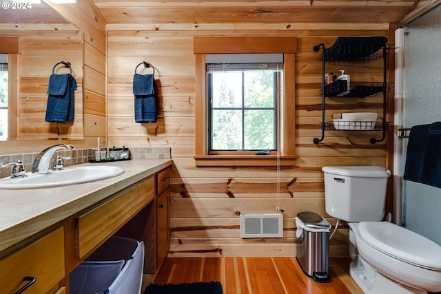 56483 Mckenzie Hwy Unit 20, Mckenzie Bridge, OR 97413 - bathroom featuring vanity, wood walls, wood finished floors, toilet, and an enclosed shower