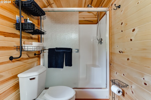 bathroom with a shower with shower door, toilet, and wood ceiling