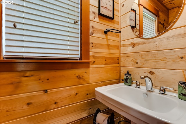 bathroom with wooden walls and sink