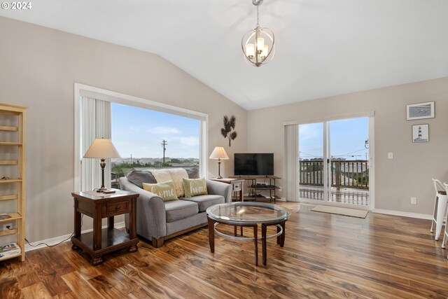 living room with hardwood / wood-style flooring and vaulted ceiling