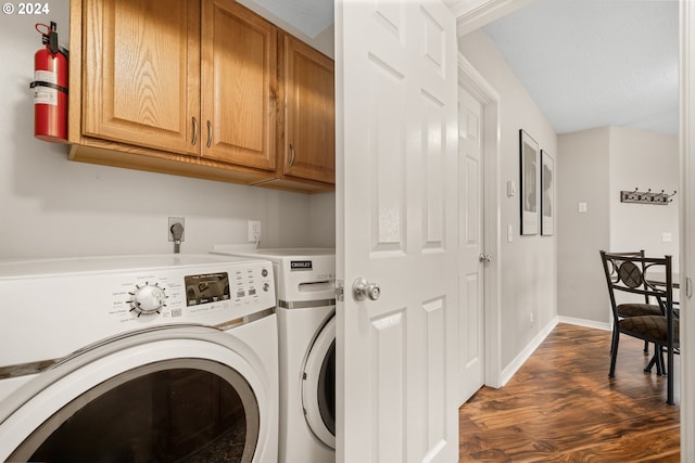 laundry area with dark hardwood / wood-style flooring, cabinets, and independent washer and dryer