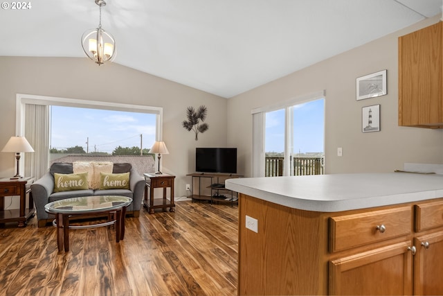 kitchen featuring hanging light fixtures, dark hardwood / wood-style flooring, and lofted ceiling