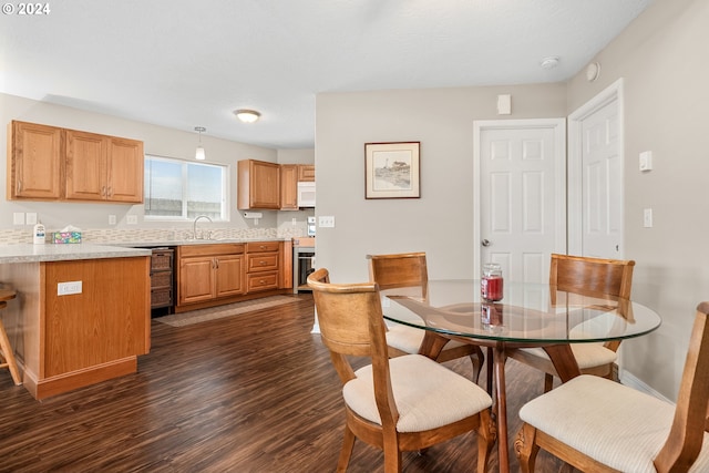 dining space with sink, wine cooler, and dark hardwood / wood-style flooring