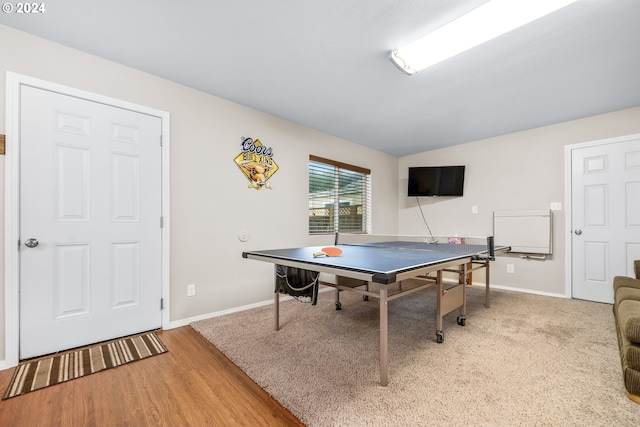 rec room featuring hardwood / wood-style flooring and vaulted ceiling