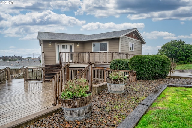 rear view of property featuring a wooden deck