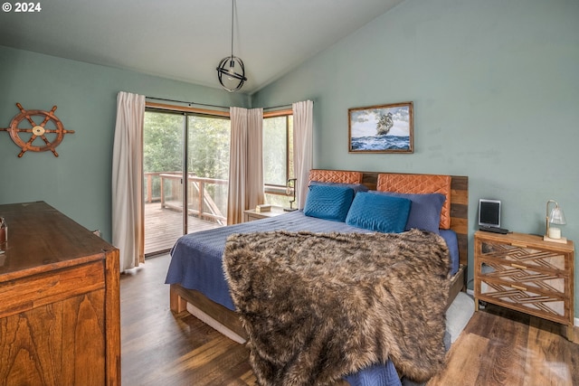 bedroom featuring access to exterior, vaulted ceiling, and wood finished floors