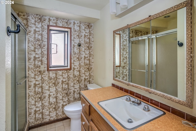 full bath with a stall shower, tile patterned flooring, vanity, and toilet