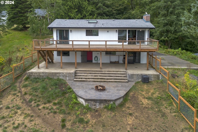 back of property featuring stairs, an outdoor fire pit, a patio area, and a wooden deck