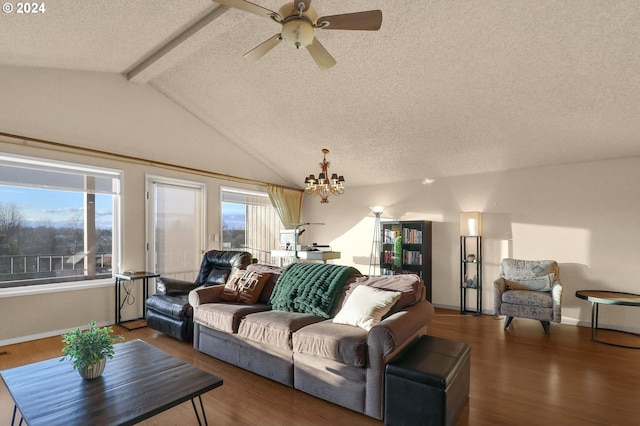 living room featuring a textured ceiling, lofted ceiling with beams, dark wood-type flooring, and a wealth of natural light