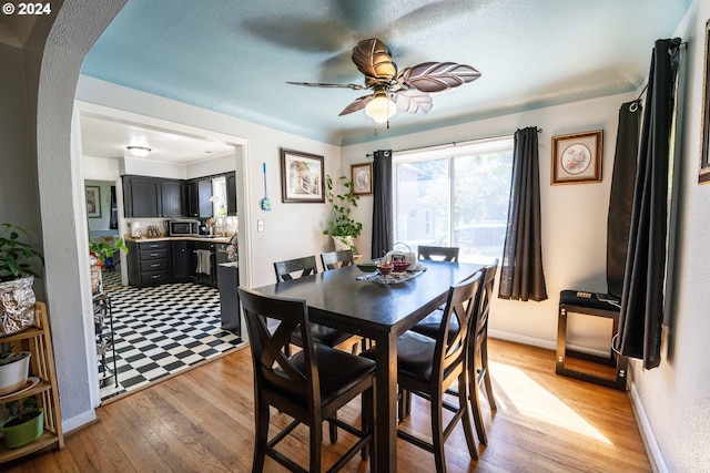 dining area featuring light wood-type flooring and ceiling fan