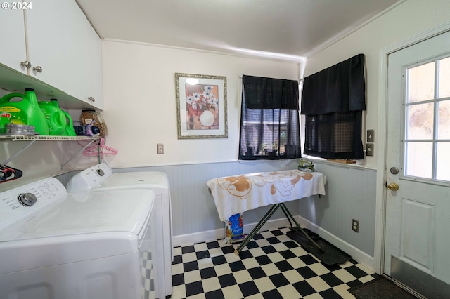 laundry room featuring cabinets, light tile patterned flooring, washer and dryer, and plenty of natural light