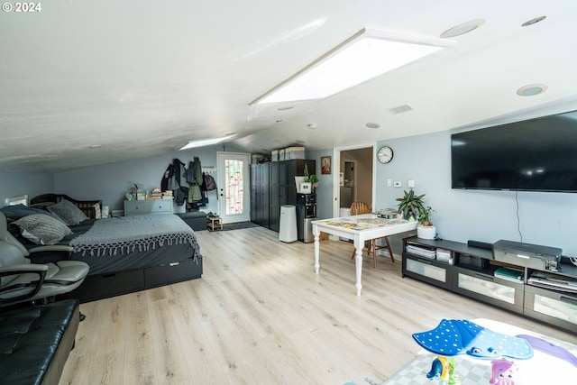 bedroom featuring light hardwood / wood-style floors and vaulted ceiling