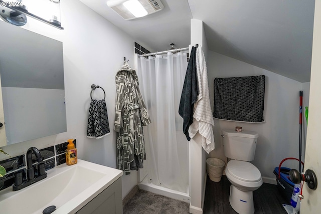 bathroom featuring a shower with curtain, toilet, and vanity