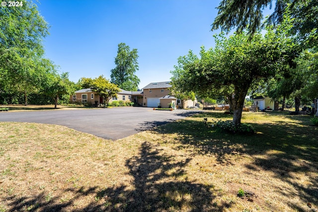 obstructed view of property featuring a front lawn