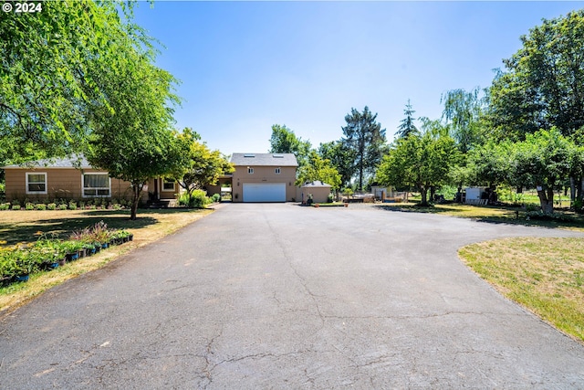 view of front of home with a garage and a front lawn