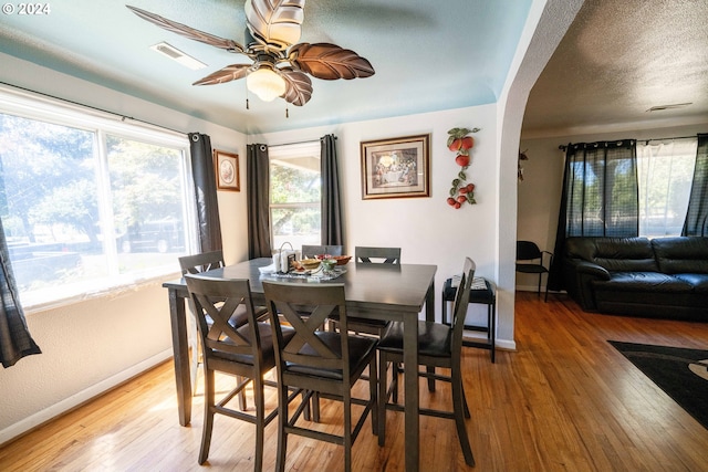 dining space featuring a textured ceiling, hardwood / wood-style floors, and ceiling fan