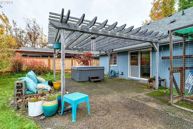 view of yard with a hot tub, a pergola, and a patio area