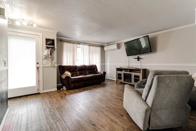 living room with hardwood / wood-style flooring, an AC wall unit, and crown molding