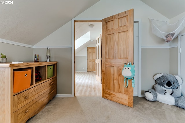 additional living space with carpet floors and lofted ceiling with skylight