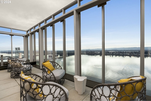 sunroom / solarium with a water view