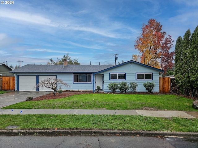 ranch-style home featuring a front yard and a garage