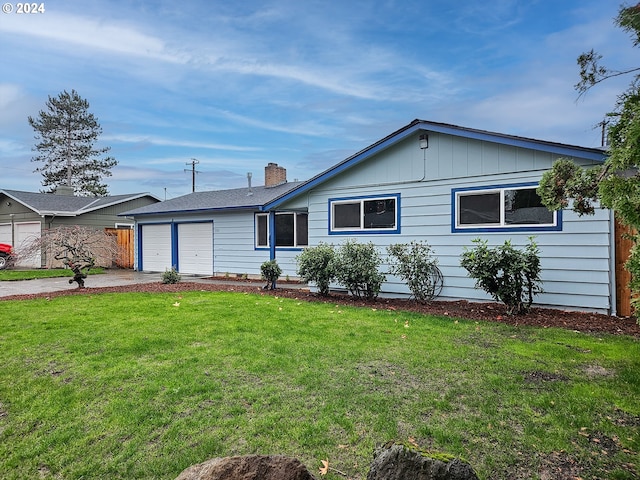 ranch-style home with a front yard and a garage