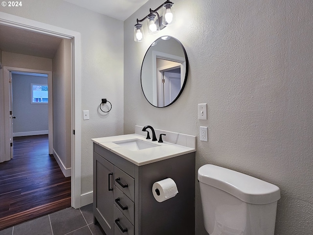 bathroom featuring hardwood / wood-style flooring, vanity, and toilet