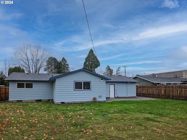 rear view of property featuring a patio area and a yard