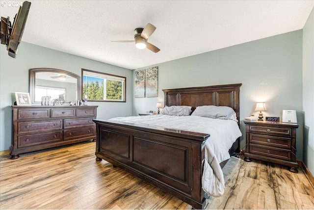 bedroom with light wood-type flooring and ceiling fan