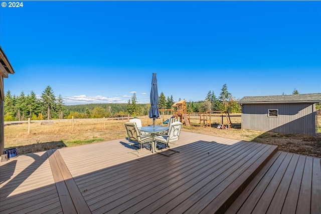 wooden deck featuring a storage unit