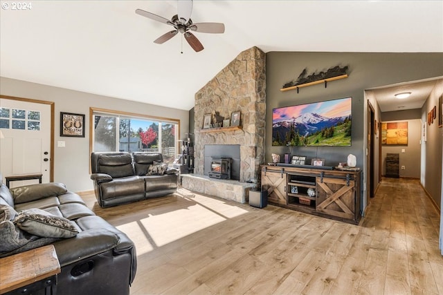 living room featuring vaulted ceiling, light hardwood / wood-style floors, and ceiling fan